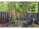 Backyard with patio featuring outdoor seating under lush green tree and fence views at 3131 Heathstead Pl, Charlotte, NC 28210