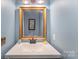Bathroom vanity with a framed mirror and bright lighting at 3131 Heathstead Pl, Charlotte, NC 28210