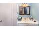 This bathroom features a vanity with a sink, a mirror, and a toilet at 3131 Heathstead Pl, Charlotte, NC 28210