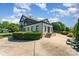 Stylish brick home with a long driveway, well maintained front lawn, and mature trees at 3131 Heathstead Pl, Charlotte, NC 28210