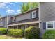 Charming two-story townhome with lush landscaping and covered front porch, perfect for relaxing outdoors at 3131 Heathstead Pl, Charlotte, NC 28210