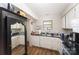 Bright kitchen with white cabinets, black countertops, stainless steel appliances and a large window at 3131 Heathstead Pl, Charlotte, NC 28210