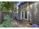 Cozy backyard patio area with wicker furniture, accessed through French doors at 3131 Heathstead Pl, Charlotte, NC 28210