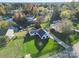 Stunning aerial view of lakeside home with lush lawn, mature trees, and private dock at 317 Commodore Loop, Mooresville, NC 28117