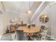 Dining room features a round wooden table, seating for six, stylish light fixture and easy access to the staircase at 317 Commodore Loop, Mooresville, NC 28117