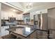Modern kitchen with stainless steel appliances, stone countertops, sleek white cabinets, and a bar seating area at 317 Commodore Loop, Mooresville, NC 28117