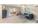 Bright living room featuring a blue sofa, bench, and an open doorway to another room at 317 Commodore Loop, Mooresville, NC 28117