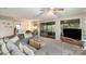 Comfortable living room area with plush seating and sliding glass doors which provide serene outdoor views at 317 Commodore Loop, Mooresville, NC 28117
