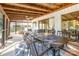 Inviting screened porch with a dining table, comfortable seating, and wooded views at 317 Commodore Loop, Mooresville, NC 28117
