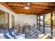 Relaxing screened porch with ample seating, ceiling fans, and a rustic wood ceiling at 317 Commodore Loop, Mooresville, NC 28117