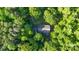 Aerial view of a house surrounded by lush, green trees at 332 York Spann Rd, Hamptonville, NC 27020