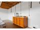 Basement kitchenette with an orange cabinet, sink and white walls at 332 York Spann Rd, Hamptonville, NC 27020