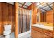 Cozy bathroom featuring wood paneled walls and a shower over tub at 332 York Spann Rd, Hamptonville, NC 27020