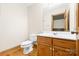 Simple bathroom with toilet, vanity, and wooden accents at 332 York Spann Rd, Hamptonville, NC 27020
