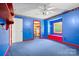 Unique bedroom with blue walls and red accents; features a built-in window seat at 332 York Spann Rd, Hamptonville, NC 27020