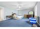 Spacious bedroom features a ceiling fan, blue carpet and light blue walls at 332 York Spann Rd, Hamptonville, NC 27020