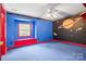 Whimsical bedroom with bright blue walls, red accents, and a fun space theme at 332 York Spann Rd, Hamptonville, NC 27020