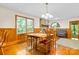 Dining room featuring hardwood floors, a stone fireplace, and natural light at 332 York Spann Rd, Hamptonville, NC 27020