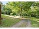 Gravel driveway leading to a wooded lot with mature trees at 332 York Spann Rd, Hamptonville, NC 27020