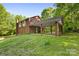 Exterior view of a two story brick house with car port and mature trees at 332 York Spann Rd, Hamptonville, NC 27020