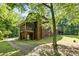Brick home featuring a screened-in porch and lush greenery at 332 York Spann Rd, Hamptonville, NC 27020