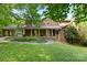 Charming brick home with covered porch and manicured front lawn creating an inviting curb appeal at 332 York Spann Rd, Hamptonville, NC 27020