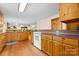 Well-lit kitchen featuring wooden cabinets and a view into the living room at 332 York Spann Rd, Hamptonville, NC 27020