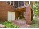Covered outdoor patio with brick pavers, bench, white doors and brick columns at 332 York Spann Rd, Hamptonville, NC 27020