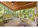 Relaxing screened porch with wood ceiling and views of the surrounding trees at 332 York Spann Rd, Hamptonville, NC 27020