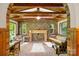 Bright sunroom features brick walls, wood ceilings, and a swing, perfect for relaxation and entertainment at 332 York Spann Rd, Hamptonville, NC 27020