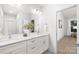 Contemporary bathroom with dual sinks, white cabinetry, modern fixtures, and a spacious layout at 3888 12Th Ne St, Hickory, NC 28601