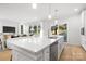 Spacious kitchen island with quartz countertop, stainless steel appliances, and a view of the living area at 3888 12Th Ne St, Hickory, NC 28601