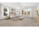 Inviting main bedroom featuring large windows, vaulted ceiling, neutral tones and plush bedding at 3888 12Th Ne St, Hickory, NC 28601