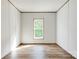 Bright bedroom with a window offers natural light and wood-look floors at 445 Davis Rd, Shelby, NC 28152