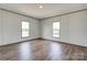Bright bedroom featuring laminate floors, neutral walls, and dual windows for ample natural light at 445 Davis Rd, Shelby, NC 28152