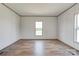 Open concept bedroom with laminate wood flooring, natural lighting, and neutral colored walls at 445 Davis Rd, Shelby, NC 28152