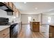 Well-lit kitchen with stainless steel appliances, wood cabinets, laminate flooring, and center island with eating area at 445 Davis Rd, Shelby, NC 28152