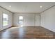 Well-lit living room boasting wood-look floors and large windows at 445 Davis Rd, Shelby, NC 28152