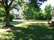 Expansive backyard featuring mature trees, lush green grass, and an abundance of natural shade at 44716 Gold Branch Rd, Richfield, NC 28137