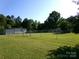 Spacious, fully fenced backyard with mature trees and lush greenery at 44716 Gold Branch Rd, Richfield, NC 28137