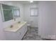 Bathroom featuring a double sink vanity, tiled floors, and a mirror reflecting the shower at 44716 Gold Branch Rd, Richfield, NC 28137