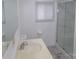Bathroom with shower, white walls, a sink, and window with blinds at 44716 Gold Branch Rd, Richfield, NC 28137