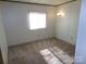 Bedroom with neutral carpet, a window with blinds, and a wall sconce at 44716 Gold Branch Rd, Richfield, NC 28137