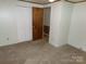 Bedroom with tan carpet and closet at 44716 Gold Branch Rd, Richfield, NC 28137