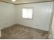 Simple bedroom with tan carpet and natural lighting at 44716 Gold Branch Rd, Richfield, NC 28137