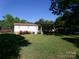 Well-maintained single-story home with a lush lawn, bright windows, and mature trees at 44716 Gold Branch Rd, Richfield, NC 28137