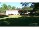Charming single-story home with a covered porch, mature landscaping, and a spacious lawn at 44716 Gold Branch Rd, Richfield, NC 28137