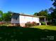 A charming single-story home with vinyl siding, lovely landscaping, and a well-maintained lawn at 44716 Gold Branch Rd, Richfield, NC 28137