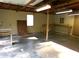 Bright garage interior with natural light, open wood beams, and workbenches at 44716 Gold Branch Rd, Richfield, NC 28137