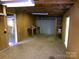 Garage interior with wood beams, plywood walls, and built-in workbench at 44716 Gold Branch Rd, Richfield, NC 28137